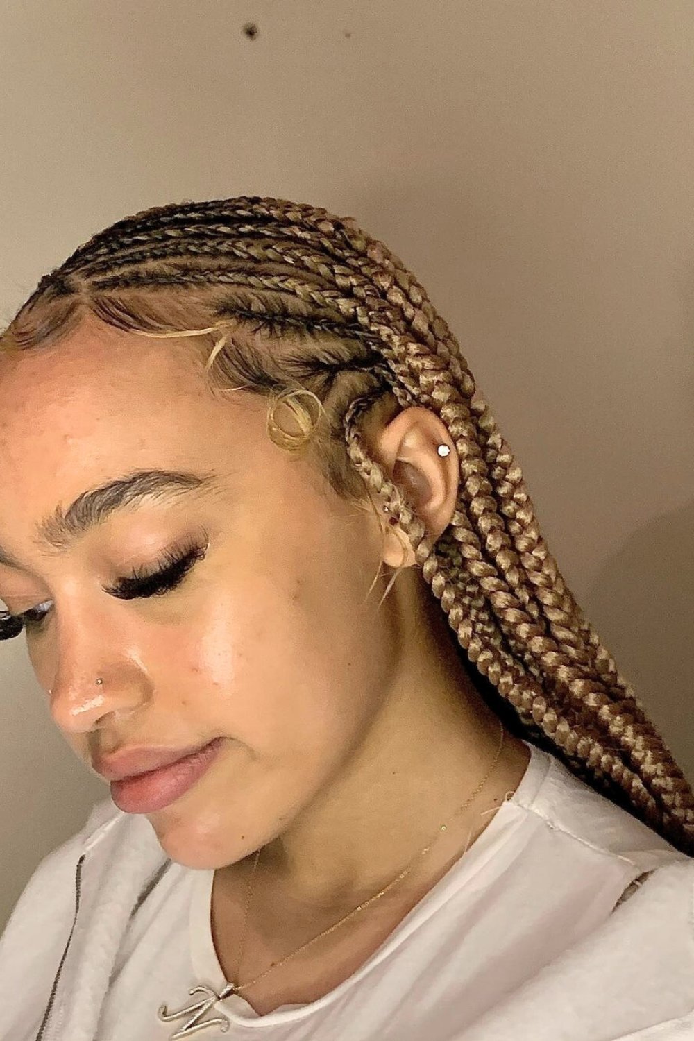 Blonde Fulani braids with sleek finish and defined edges