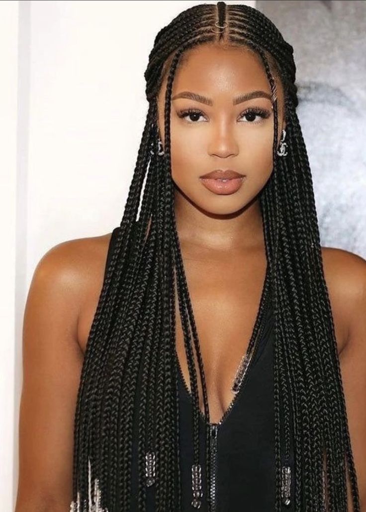 Sleek Fulani braids with center part and glossy finish
