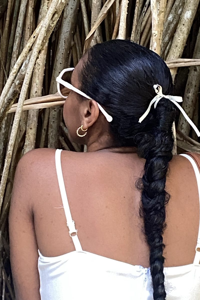 Sleek braided ponytail with ribbon accent