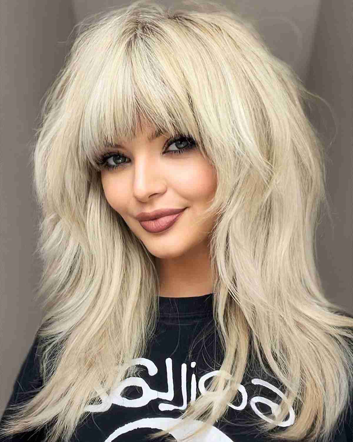 Blonde layered waves with full bangs