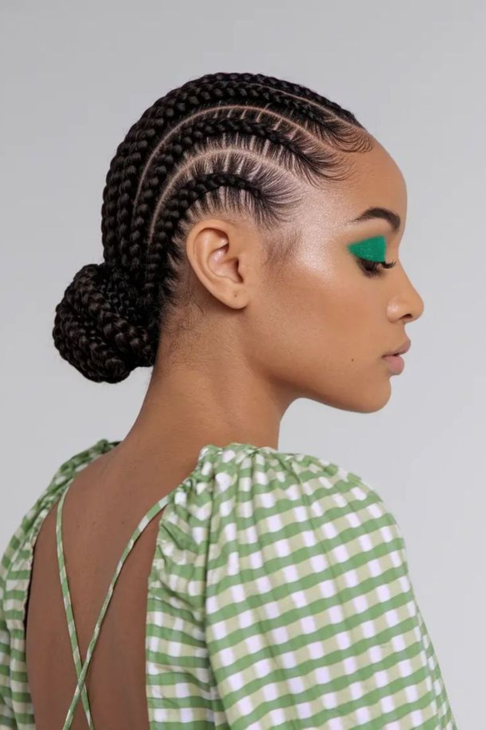 Sleek cornrow bun with polished finish