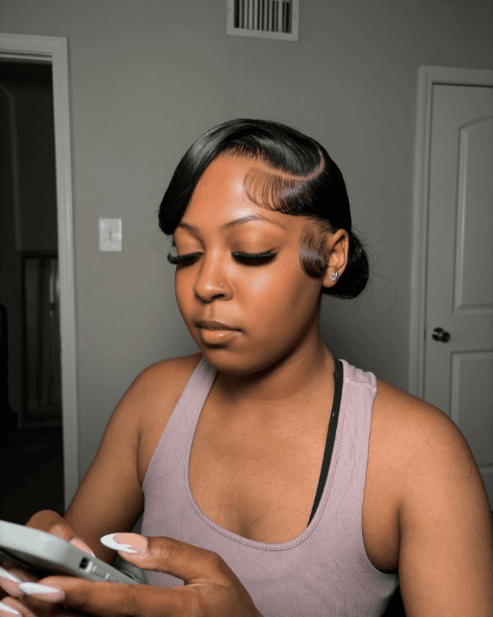 Sleek sculpted side bun with sleek finish