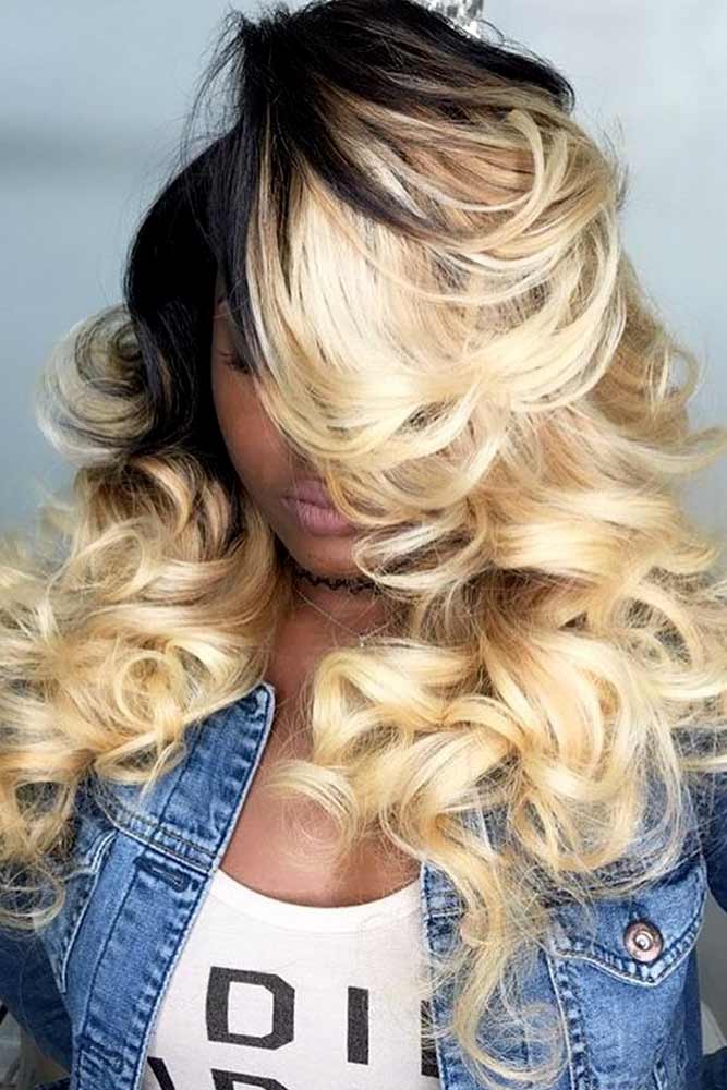 Bold blonde curls with dark roots