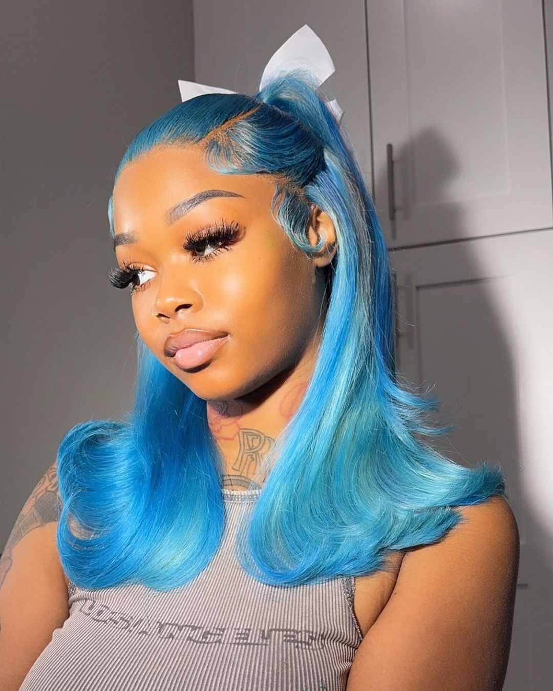 Vibrant blue half-up hairstyle with curls