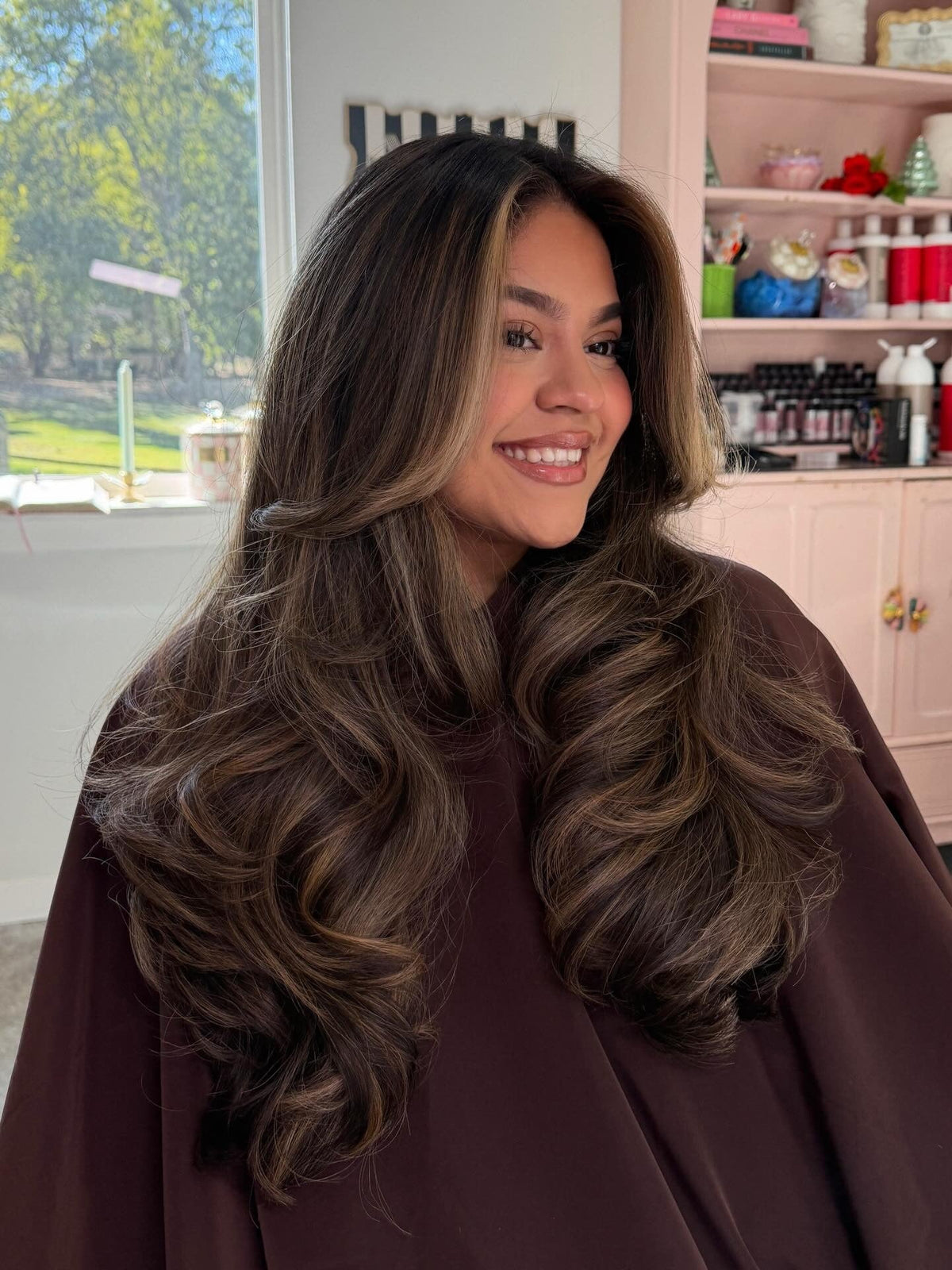 Voluminous brunette with subtle rose gold highlights