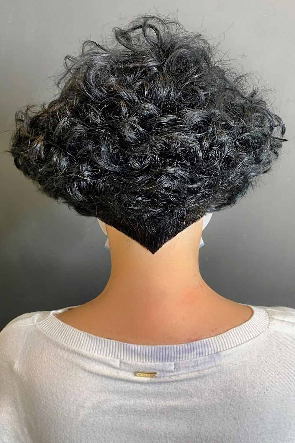 Edgy undercut curls, bold and striking