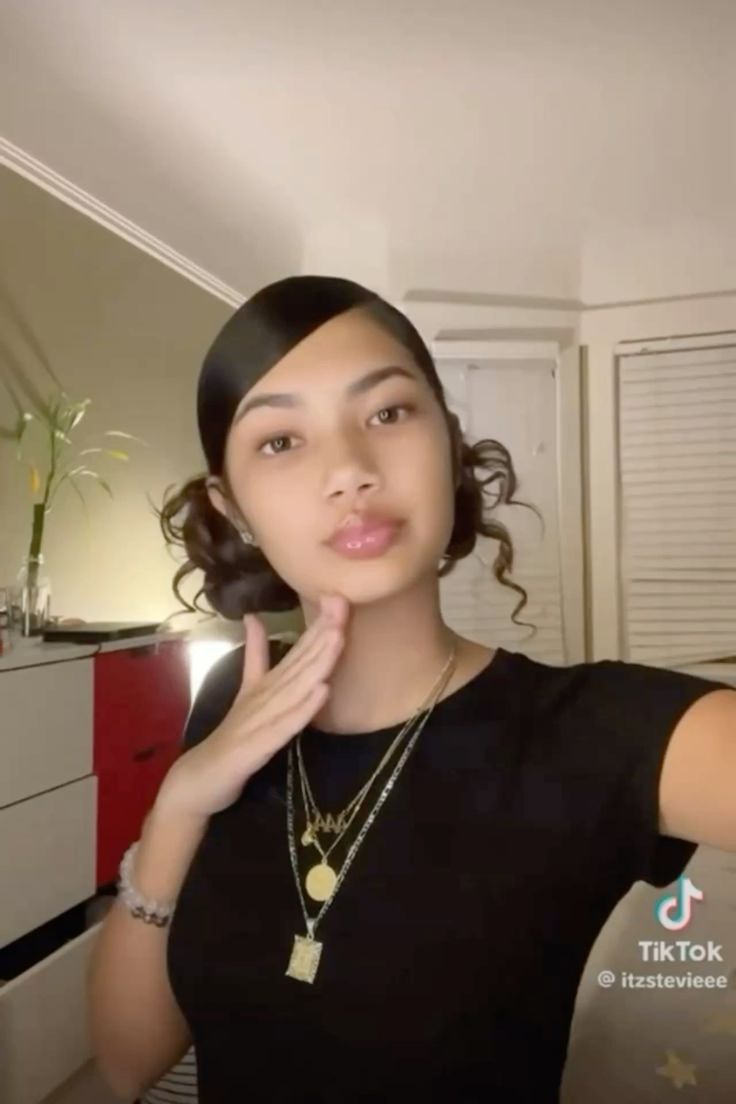 Playful side part with low buns and curls