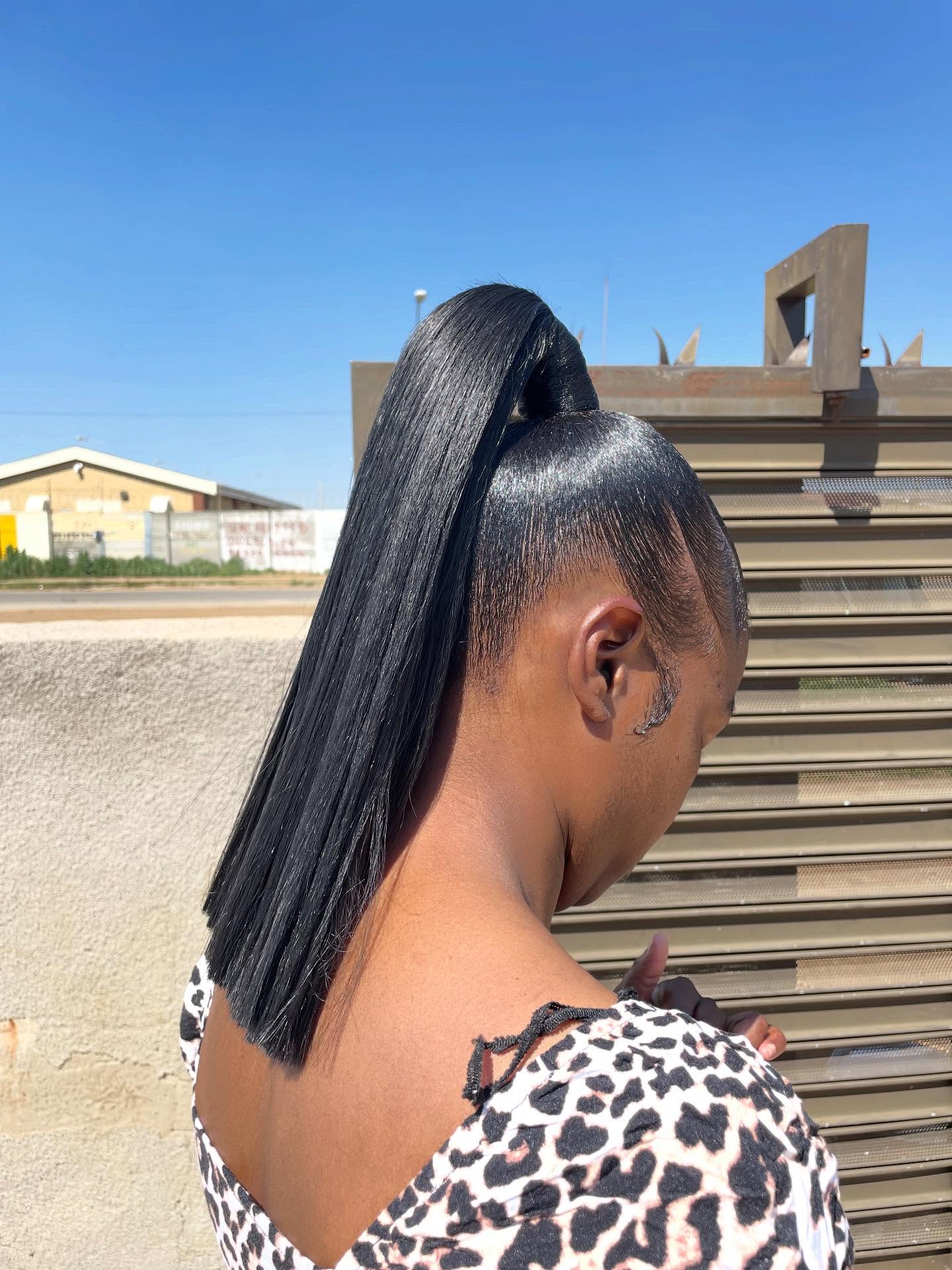 Sleek high ponytail with shiny finish