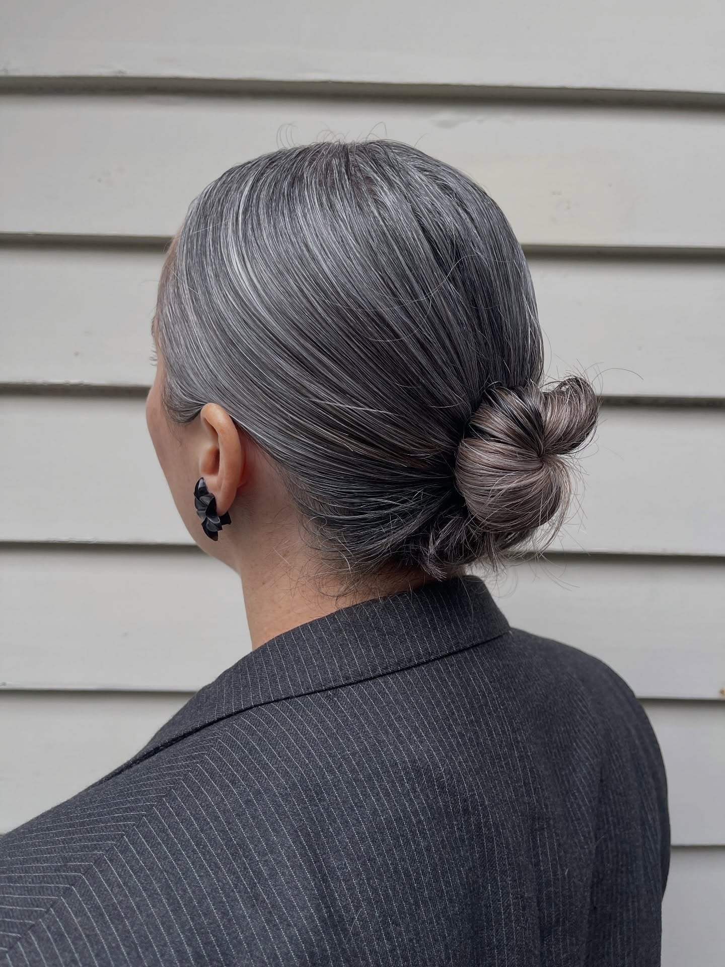 Low bun with sleek gray hair