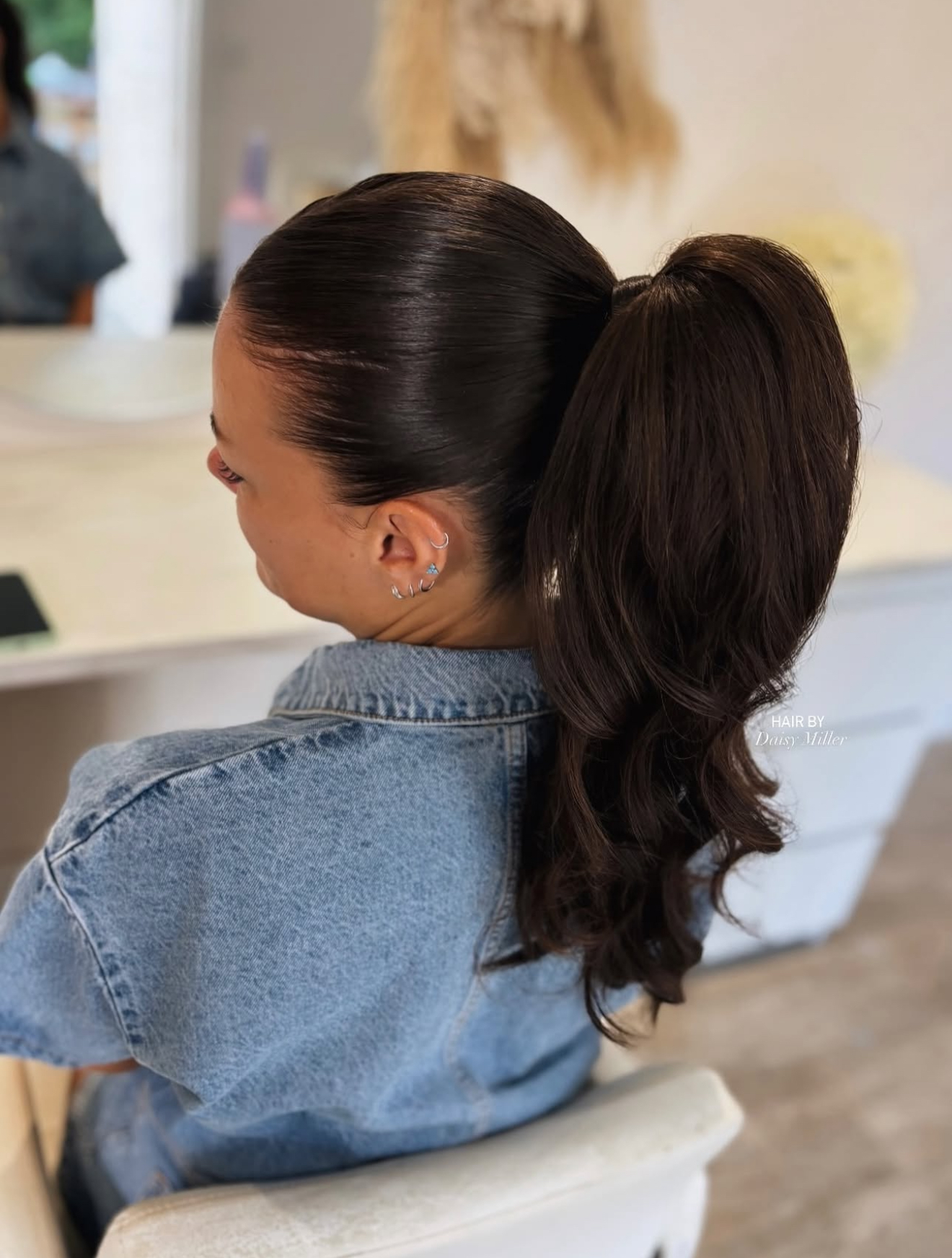 Sleek high ponytail with glossy finish