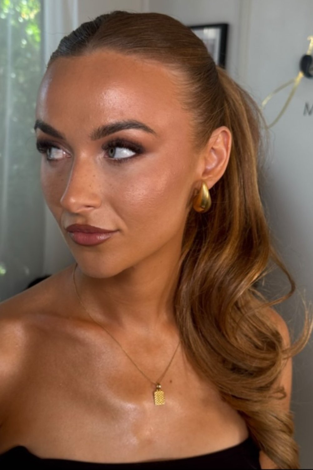 Side-swept curls with glossy finish