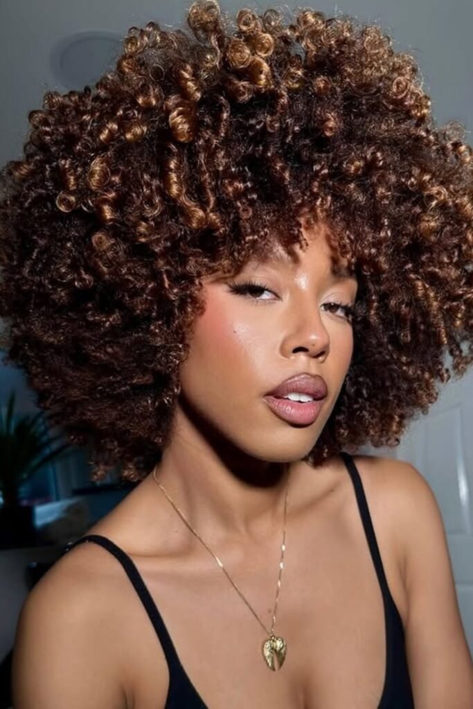 Voluminous afro curls, bold and dynamic, statement style.