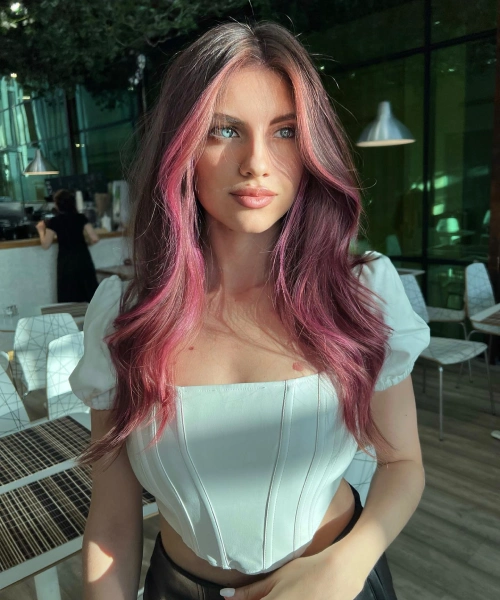 Vibrant rosewood ombré hair, bold spring transformation, playful gradient style