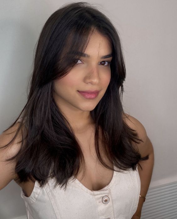 Soft curtain bangs with natural waves, relaxed style, spring 2026