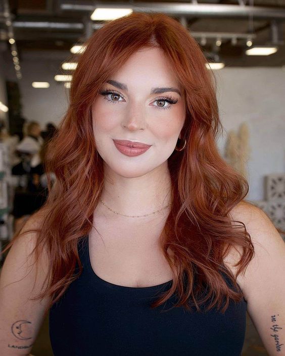 Vibrant copper waves, bold color, lively hairstyle