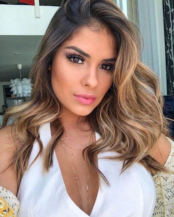 Sunlit waves with subtle highlights, relaxed and radiant, trending hairstyle