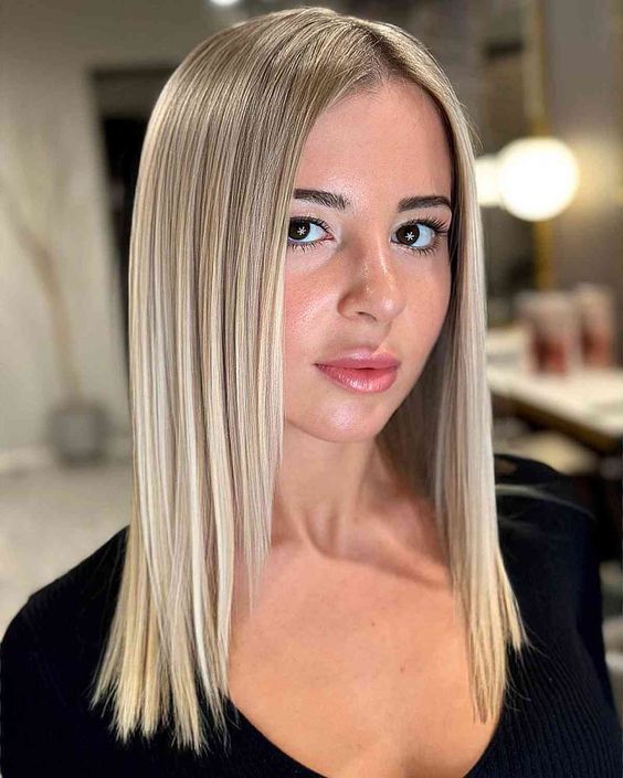 Sleek straight cut with glossy finish, polished and refined, modern hairstyle