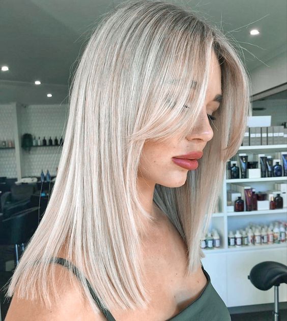Sleek platinum lob with side part, modern elegance, trending hairstyle