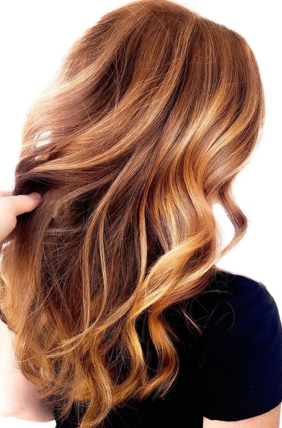 Rich auburn waves with strawberry blonde highlights