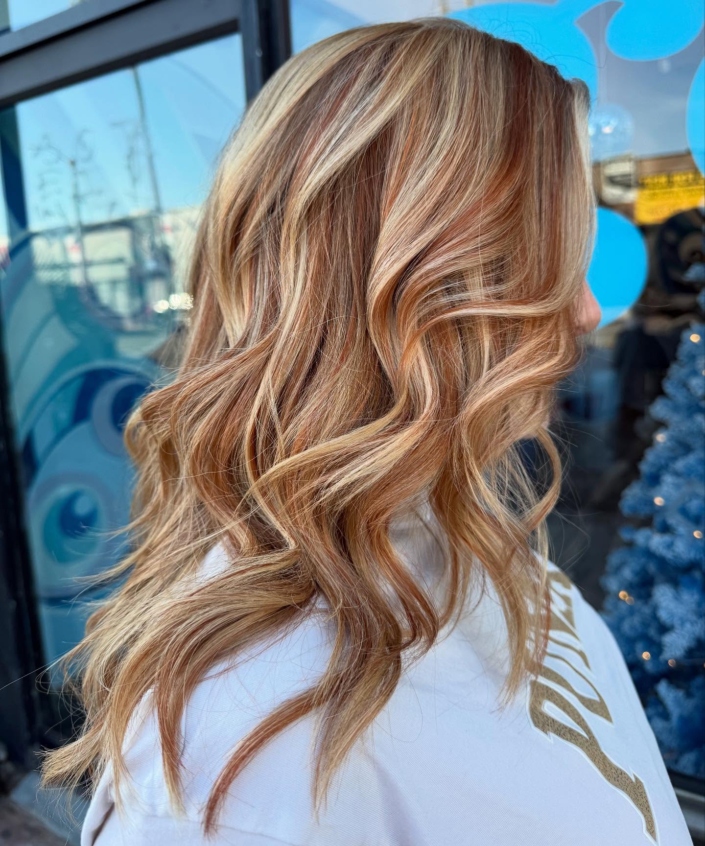 Dimensional balayage waves with strawberry blonde highlights