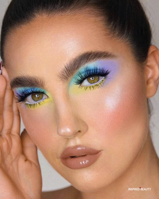 Pastel rainbow eye makeup with bold brows and glossy lips