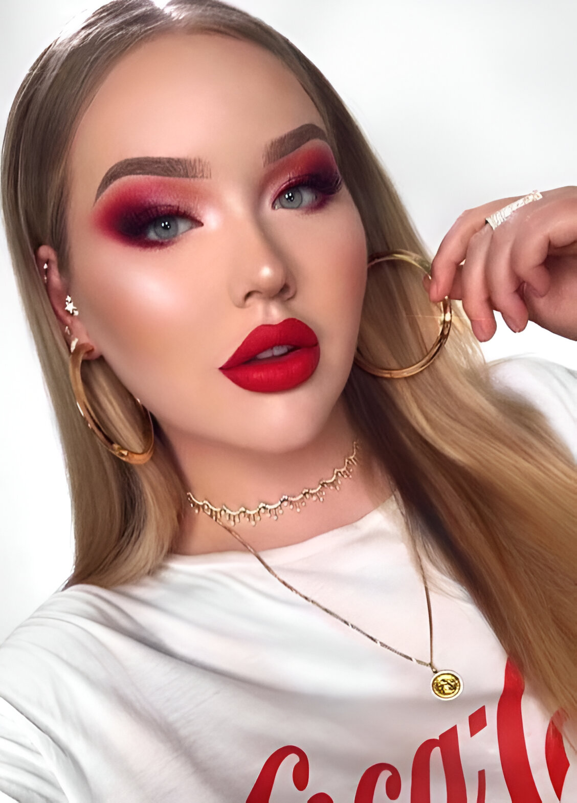 Intense red eyeshadow and lipstick with defined brows