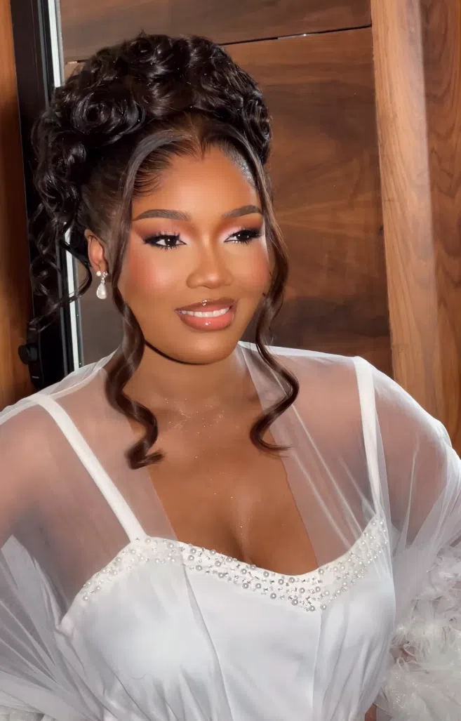 Glamorous bridal makeup with dewy skin and intricate hairstyle