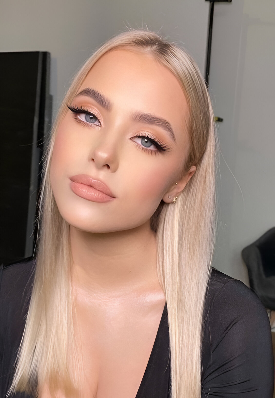 Nude lipstick and winged liner with straight hair