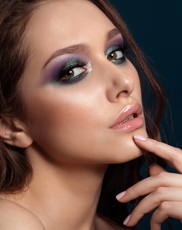 Vibrant jewel-toned eye makeup with sparkle