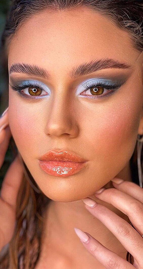 Soft blue eye makeup with glossy lips
