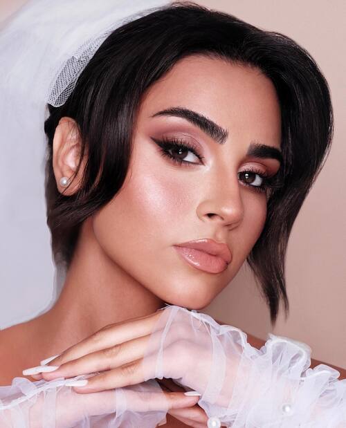 Glam makeup with bold eye and nude lips