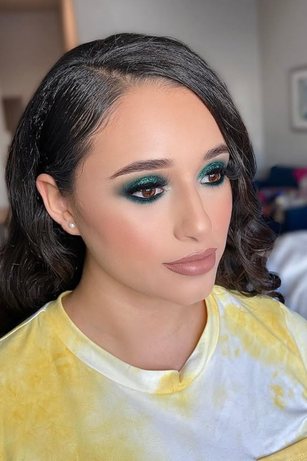 Smoky green eye makeup with nude lips