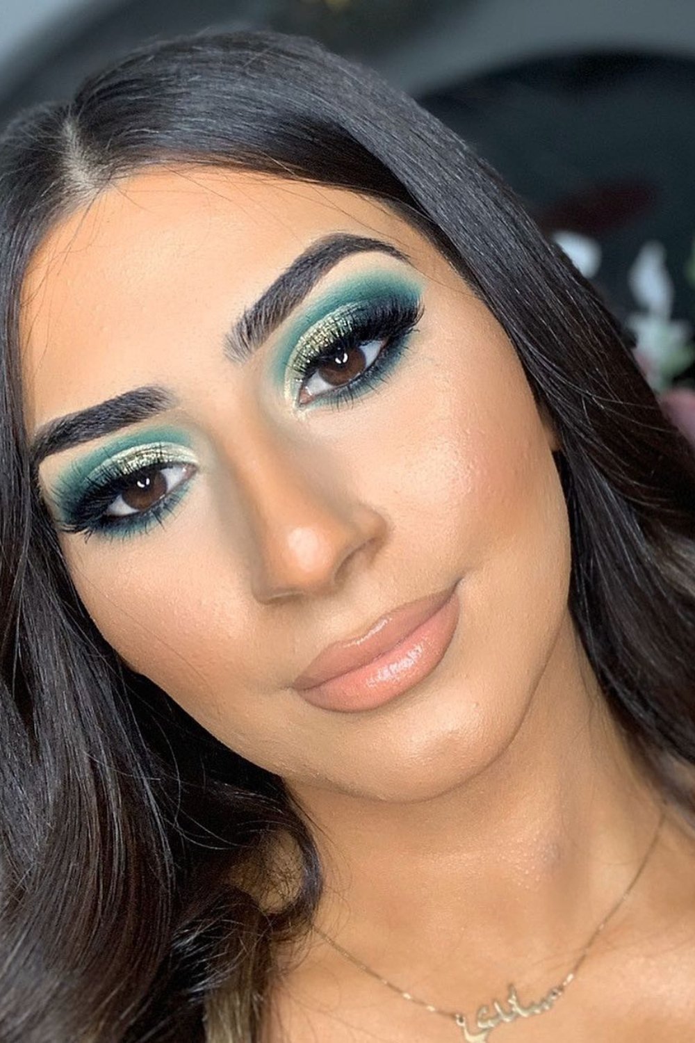 Emerald green smokey eyes with nude lips