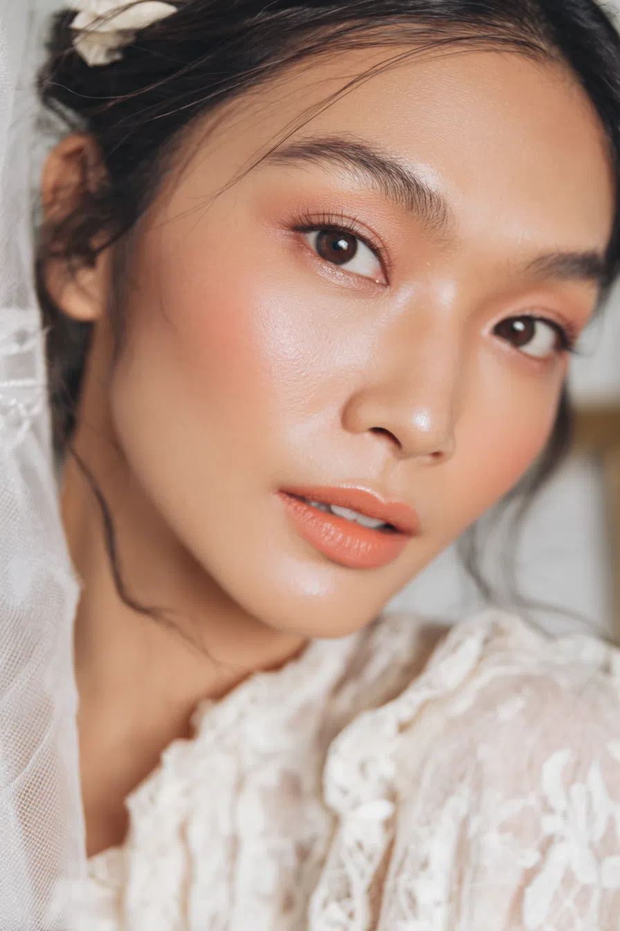 Soft glow wedding makeup with peachy tones