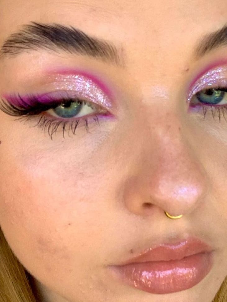 Vibrant pink eye makeup with glitter and bold lashes