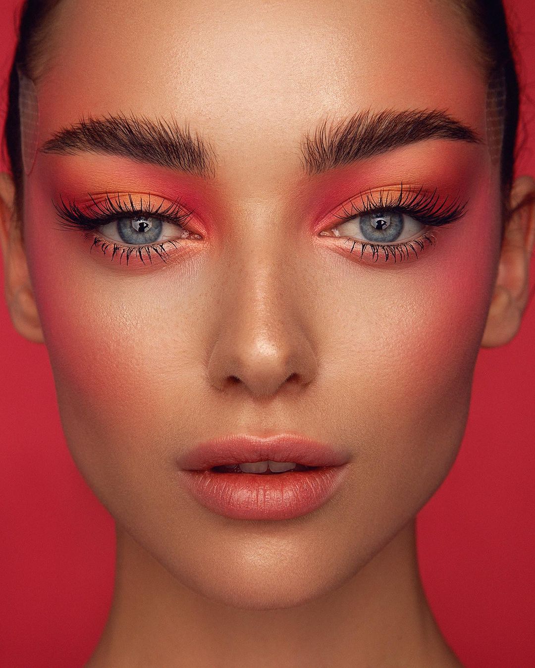 Bold pink blush with strong brow look