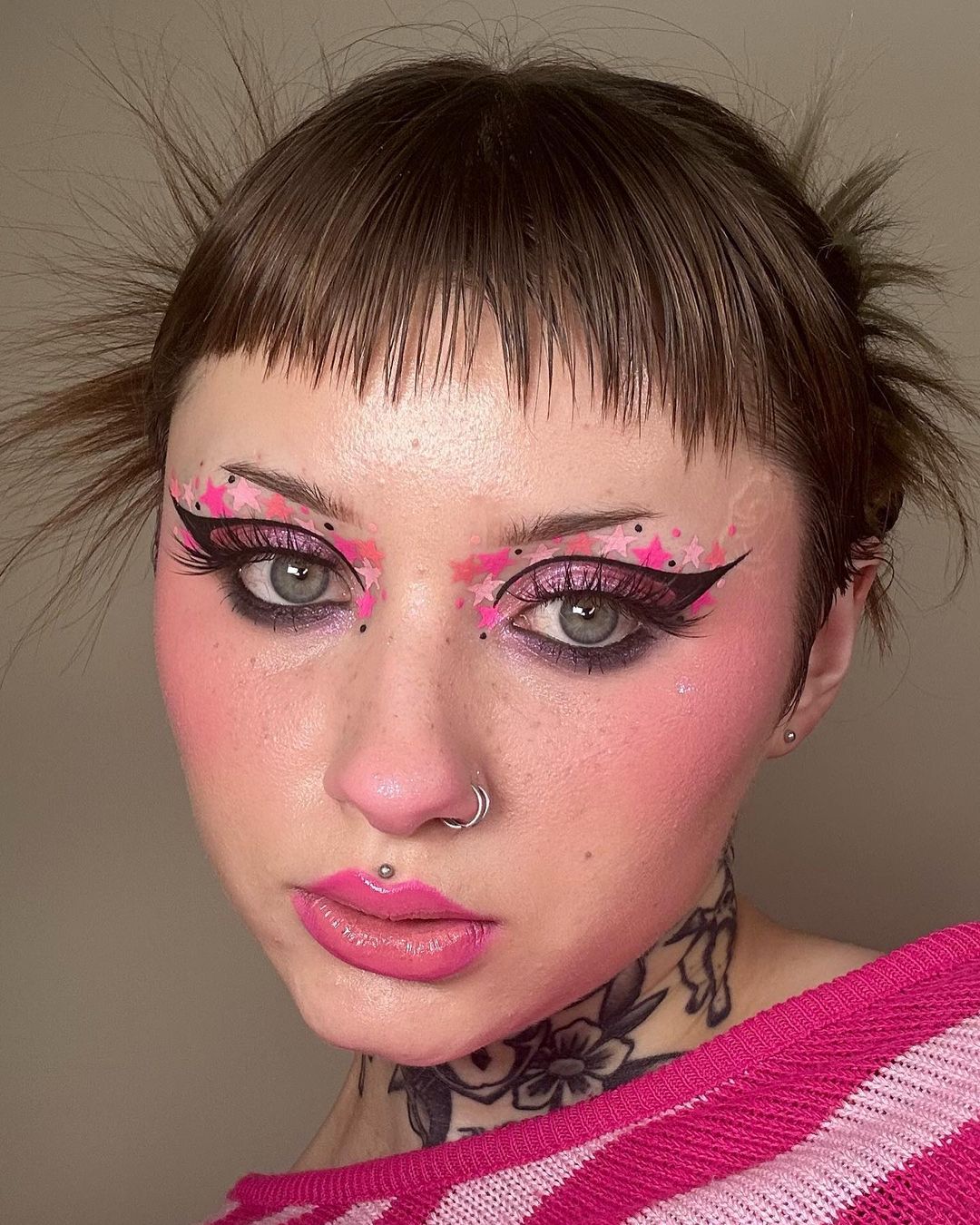Bold pink graphic eye makeup with blush