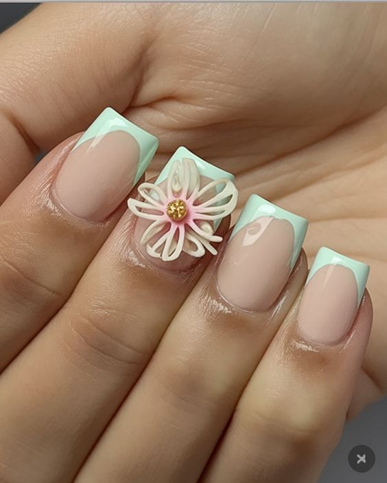 Nude nails with mint French tips and floral accent