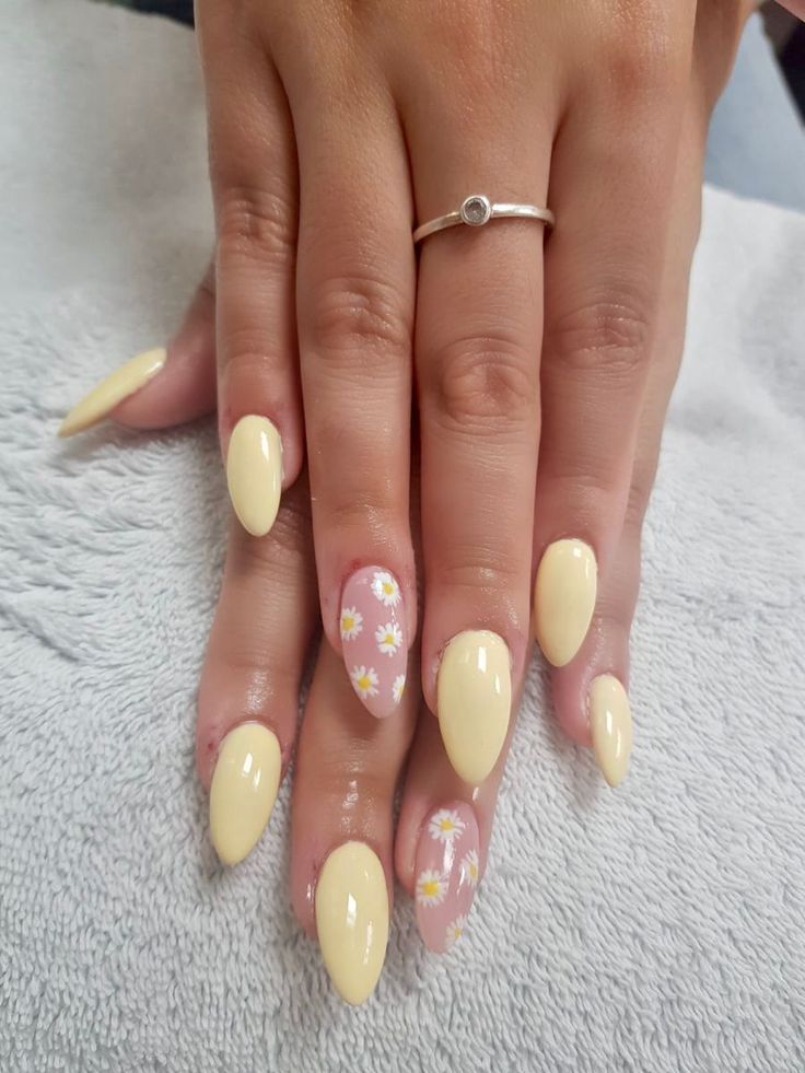 Yellow almond nails with daisy patterns