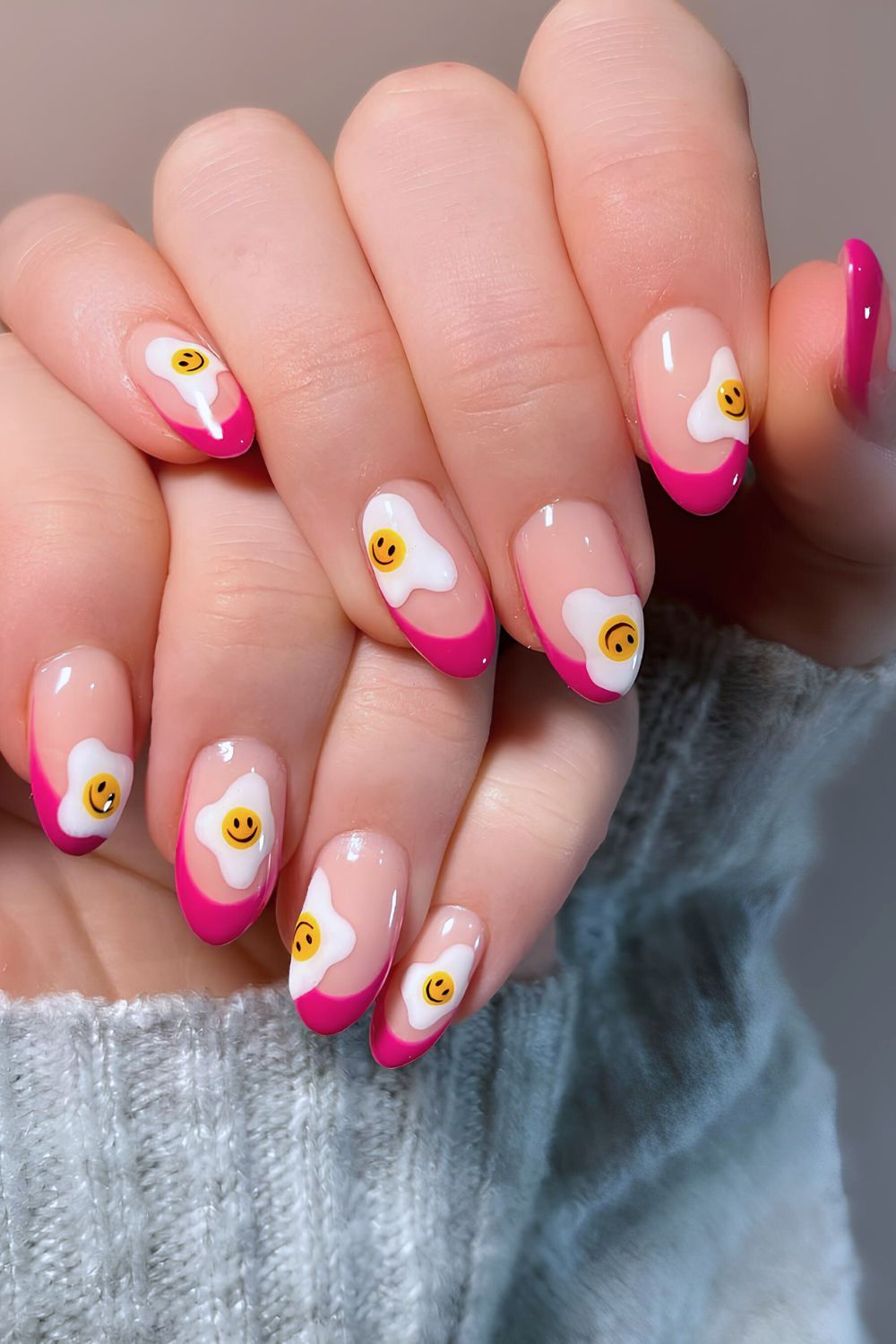 Pink nails with egg and smiley face designs