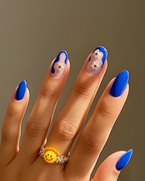 Bold blue nails with floral accents