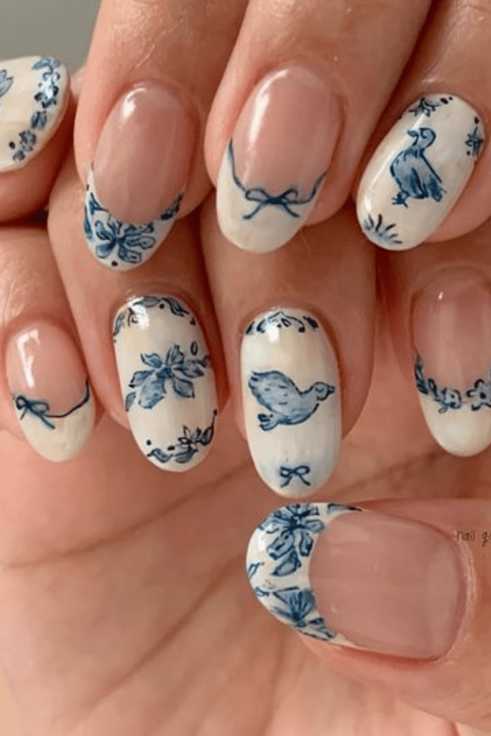 Blue floral French tip nails with intricate designs