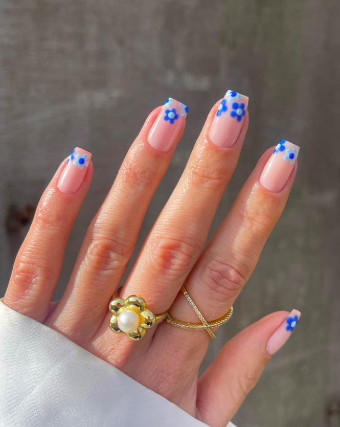 Whimsical blue blossom French tips with playful design