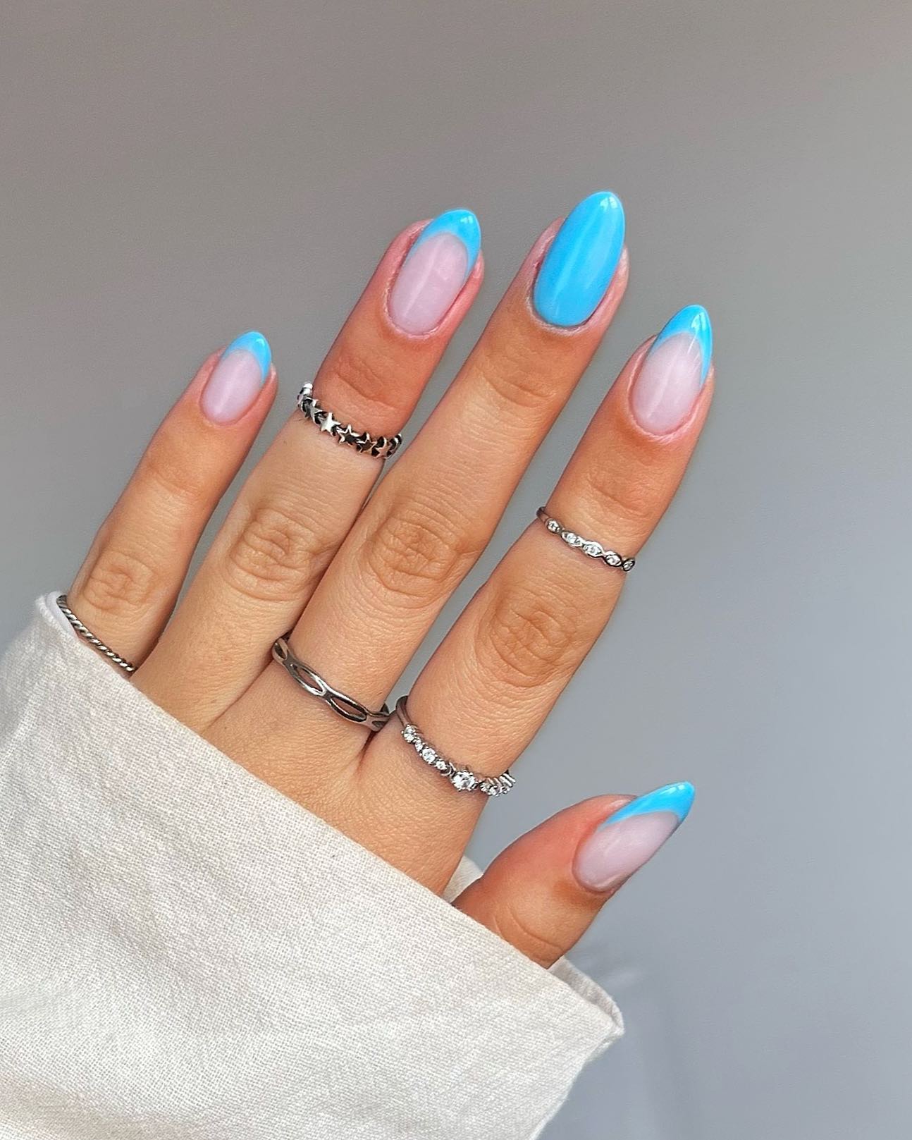 Bright blue French tips on almond nails