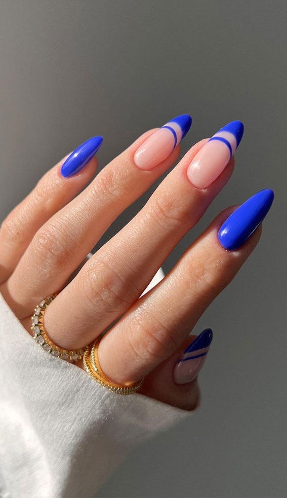 Vibrant blue French tips with double lines on almond nails