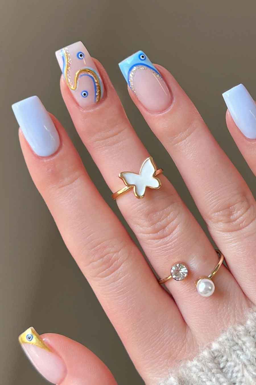 Playful blue French tips with swirls on square nails