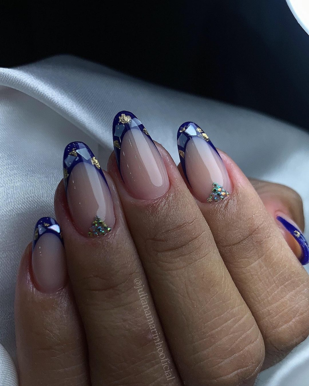 Elegant blue and gold checkered French tips on oval nails