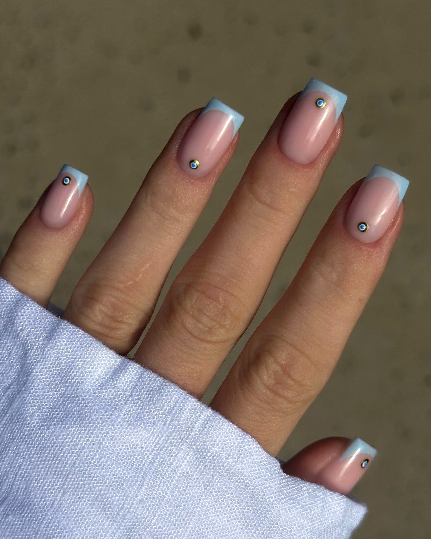 Pastel blue square French tips with rhinestones on short nails