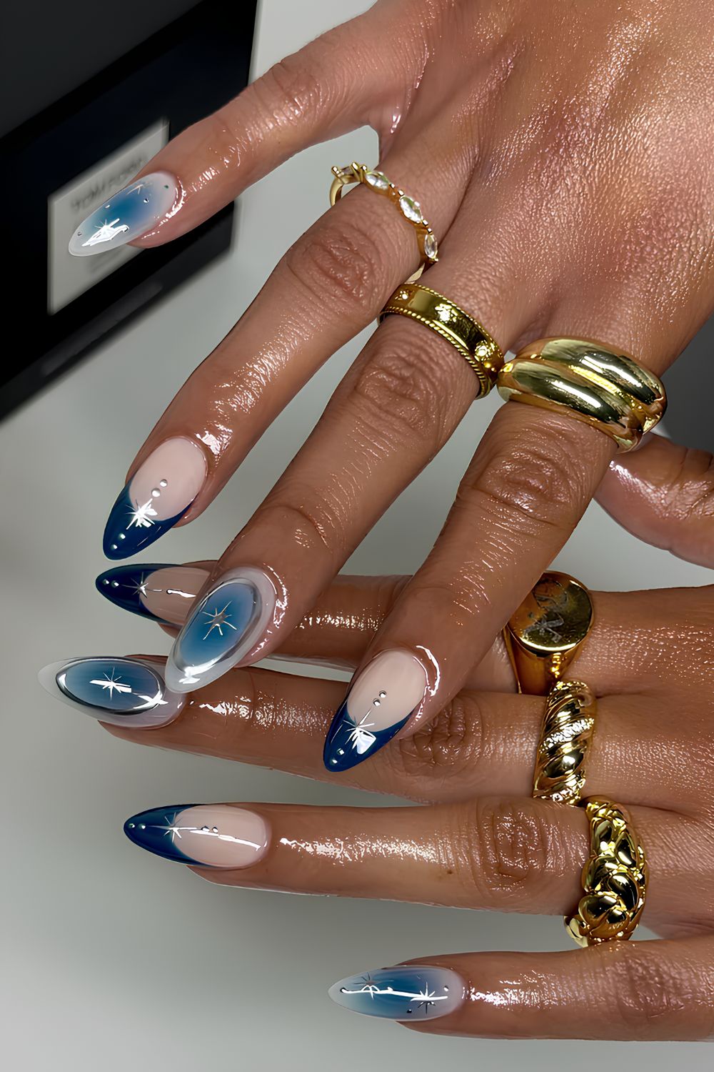 Blue ombre stiletto nails with star accents
