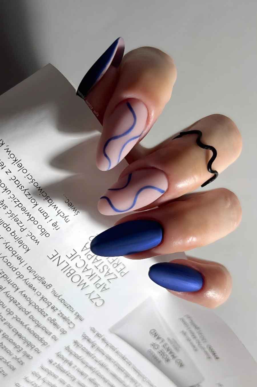 Matte blue nails with abstract lines
